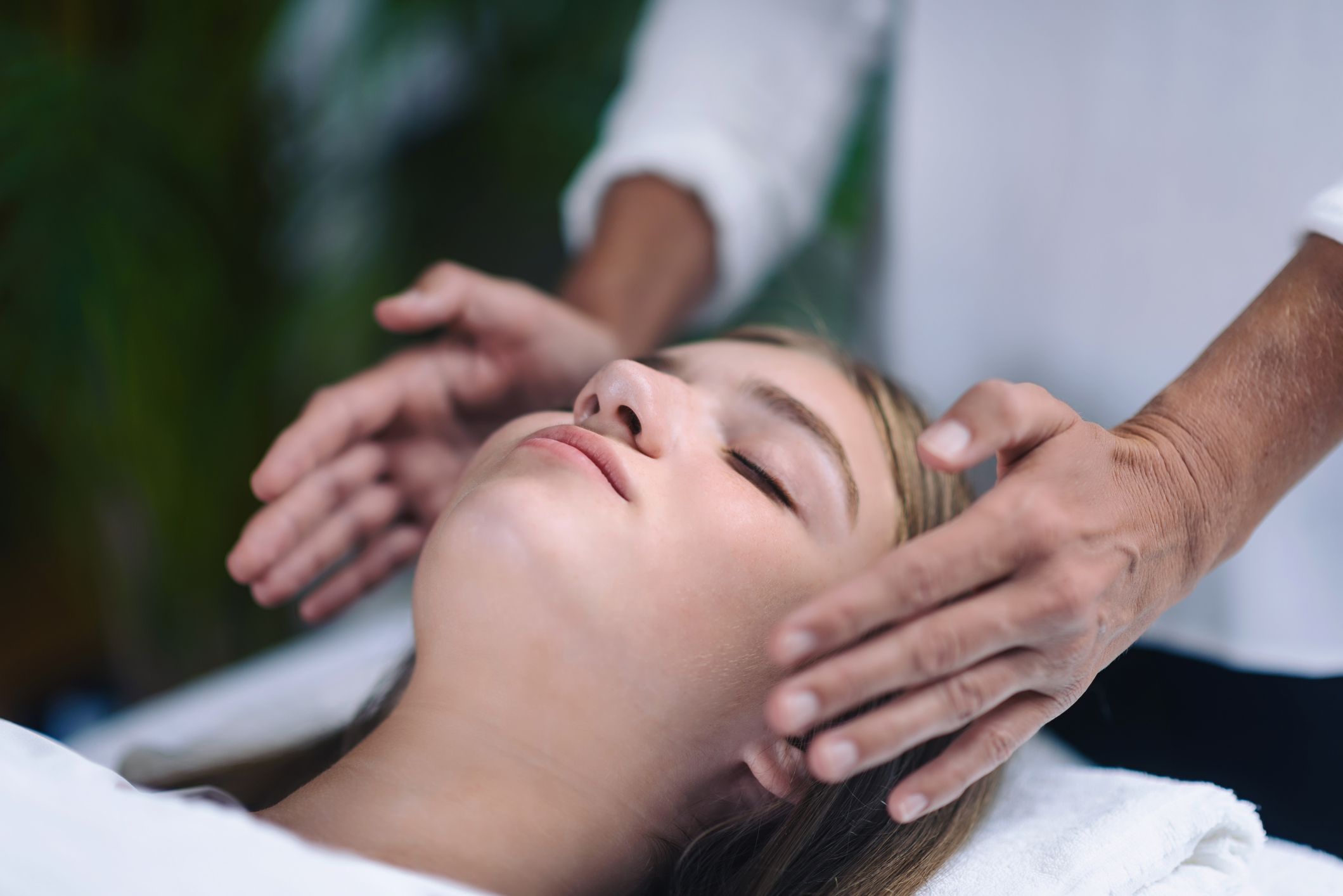 Midsection of therapist giving reiki treatment to royalty
