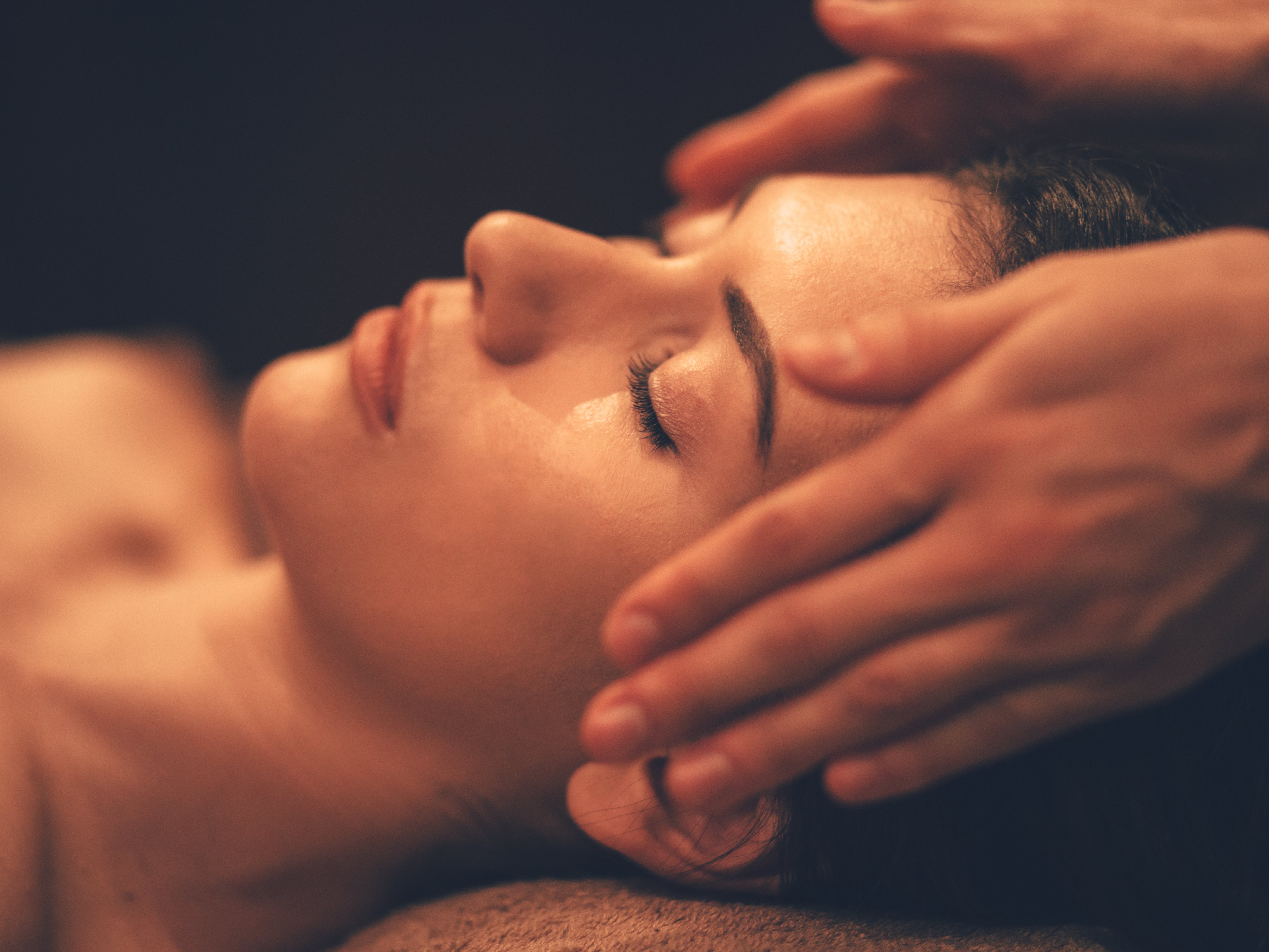 A Woman In Bed Doing Reiki
